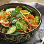 Cucumber and carrot salad with a handwritten recipe card