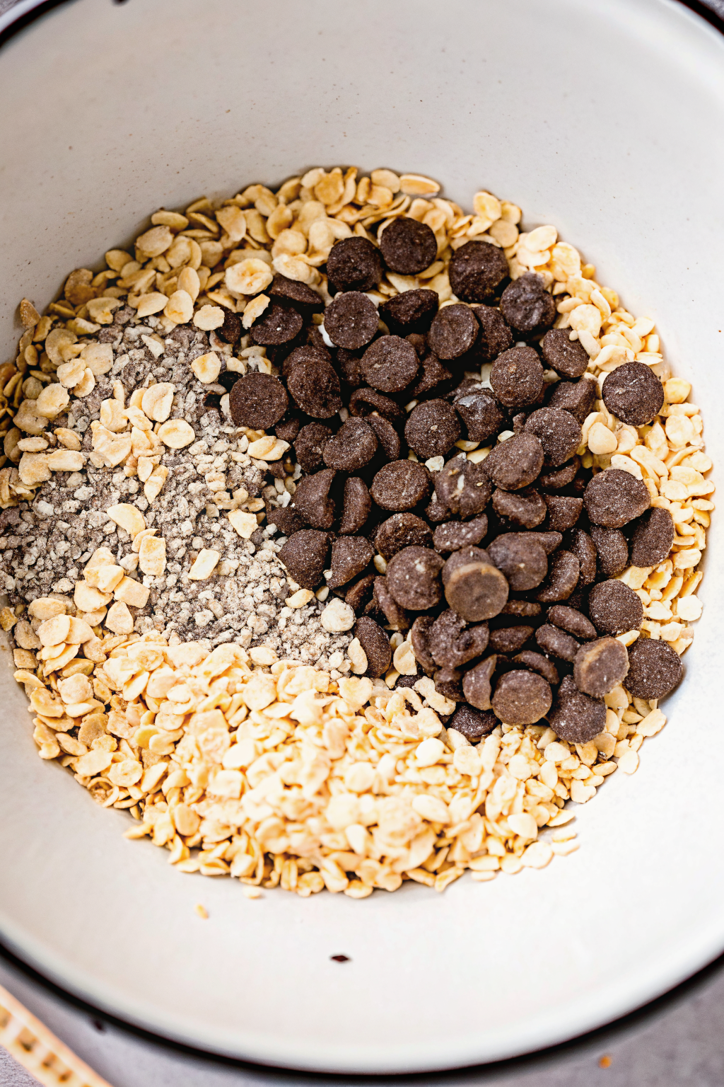 PB-Chocolate-Oatmeal-Balls-Instruction-2 Mixing oats, chocolate chips, and chia seeds in a bowl