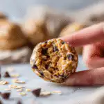 Bitten no bake peanut butter oatmeal energy ball on white marble