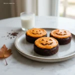 Jack O Lantern Brownies served on a rustic plate.