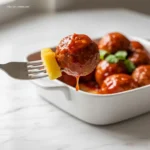 Close-up of a sweet and sour meatball being served