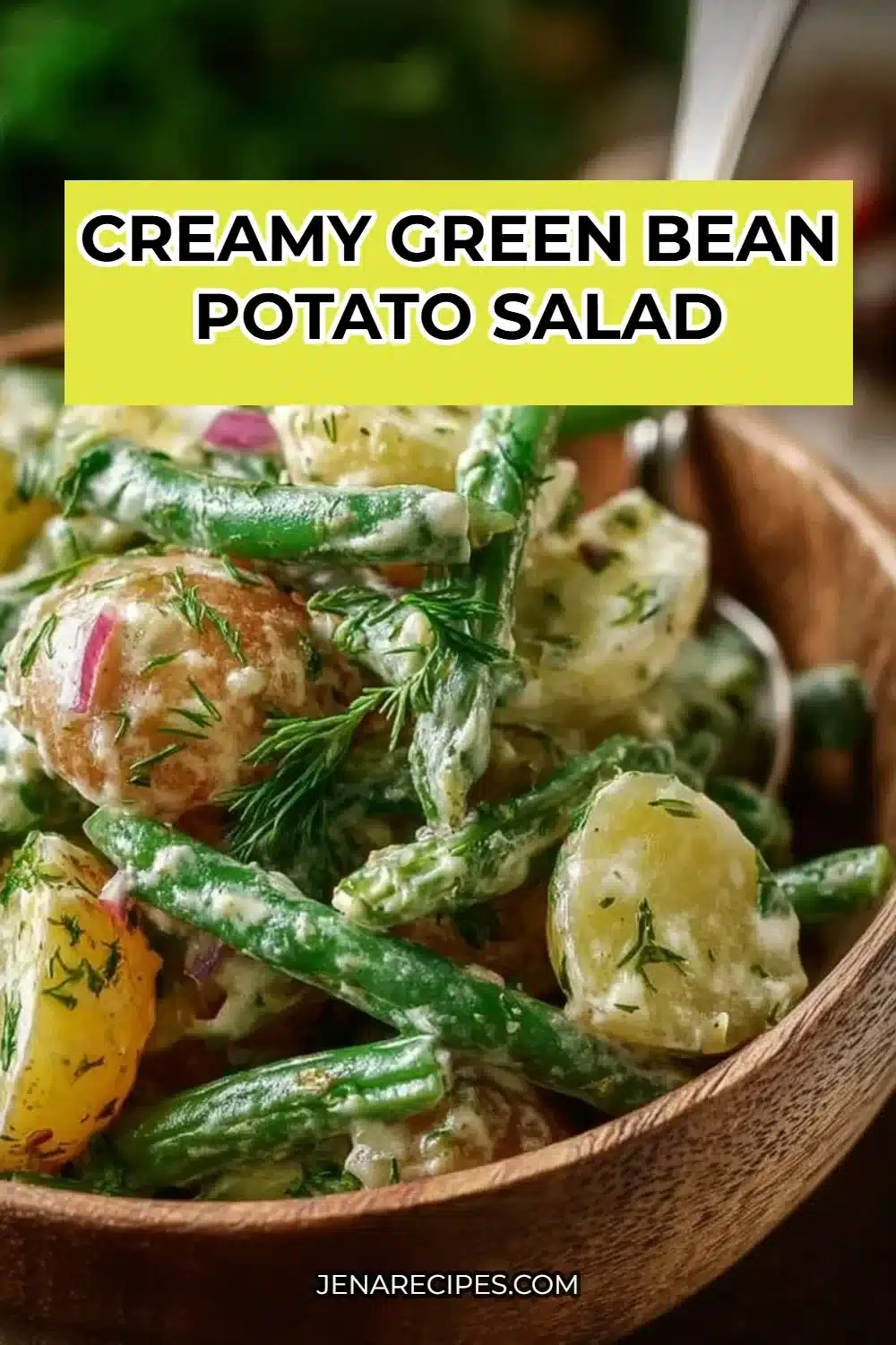 Creamy green bean potato salad served in a bowl with fresh herbs