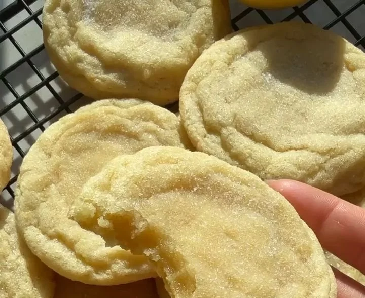 Soft and chewy lemon cookies with a bright yellow color and citrus glaze