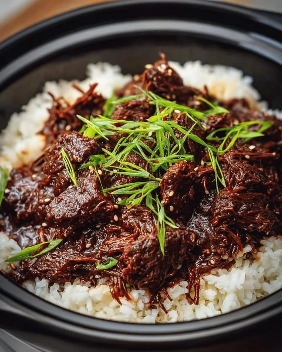 Delicious Slow Cooker Korean Beef served with rice and vegetables.