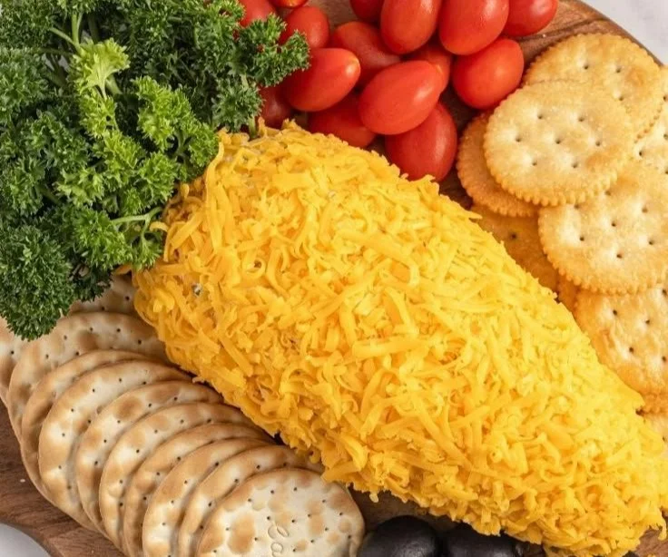 Delicious carrot cheeseball served with fresh vegetables and crackers