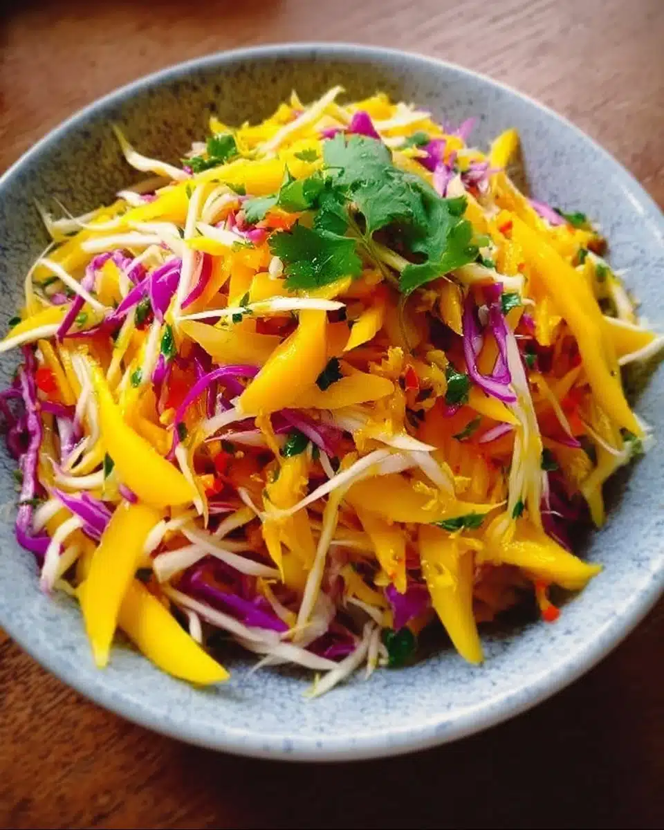 Delicious mango slaw served in a bowl with fresh ingredients.